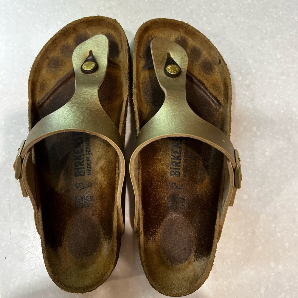 Gold Birkenstocks Gizah sandals